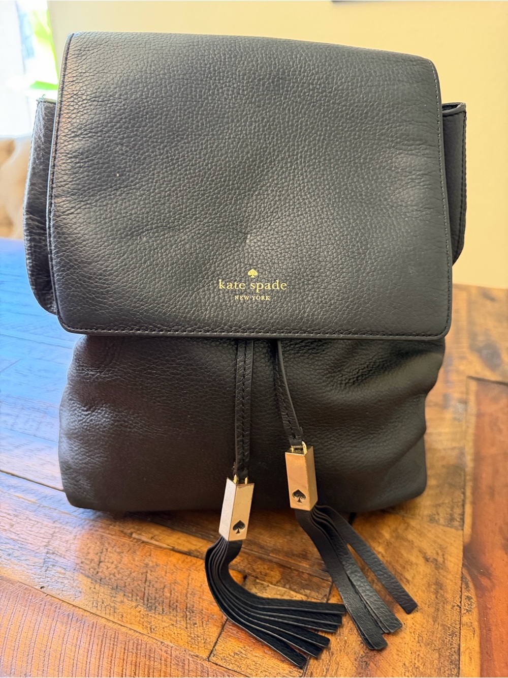 kate spade Black Leather Drawstring Backpack with Gold Tassel Accents